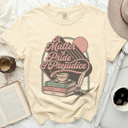 Cream t-shirt with "A Matter of Pride & Prejudice" graphic, teacup, books, and quill.