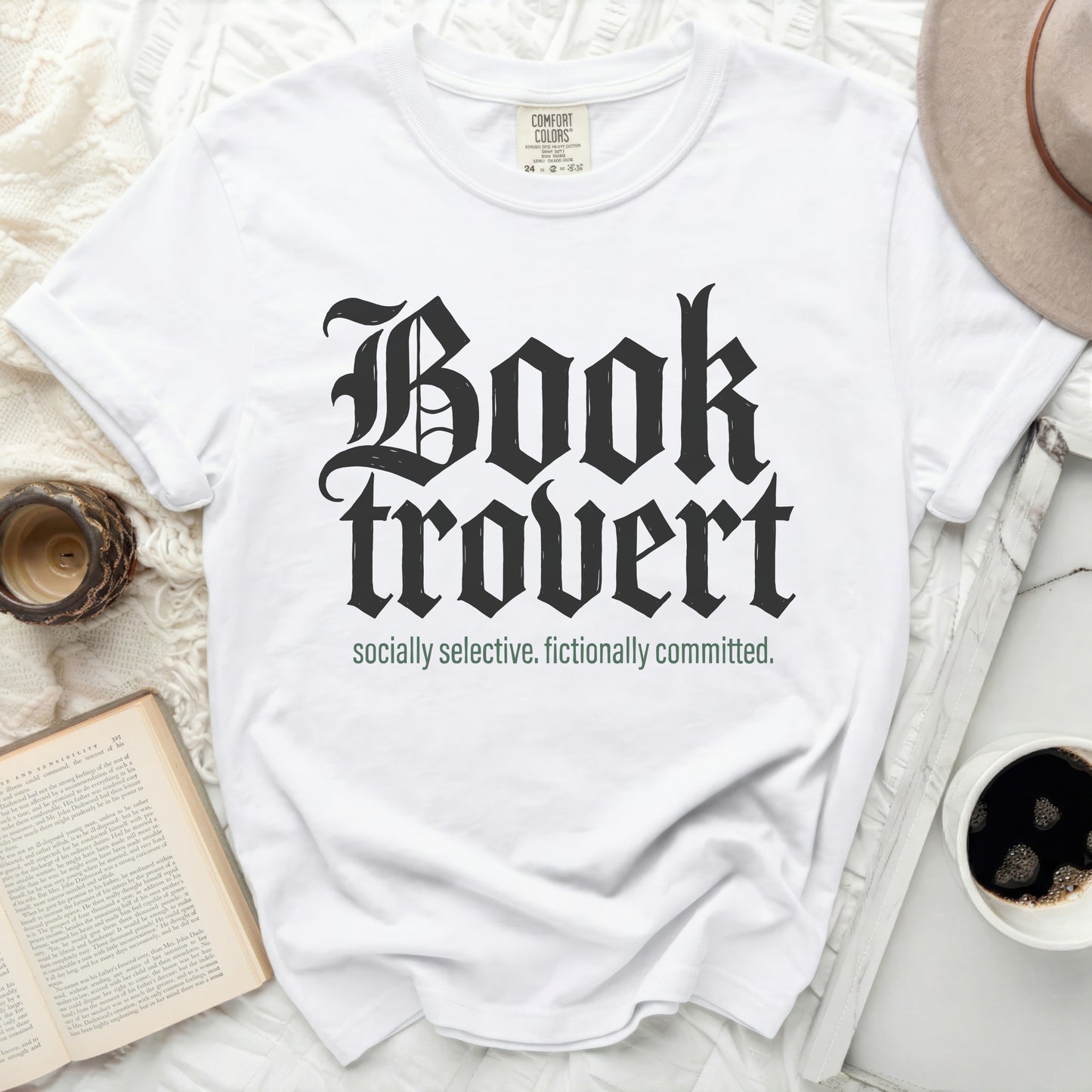 White t-shirt with "Booktrovert socially selective. fictionally committed." text.