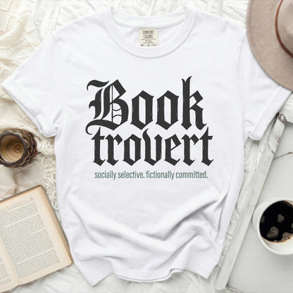White t-shirt with "Booktrovert socially selective. fictionally committed." text.