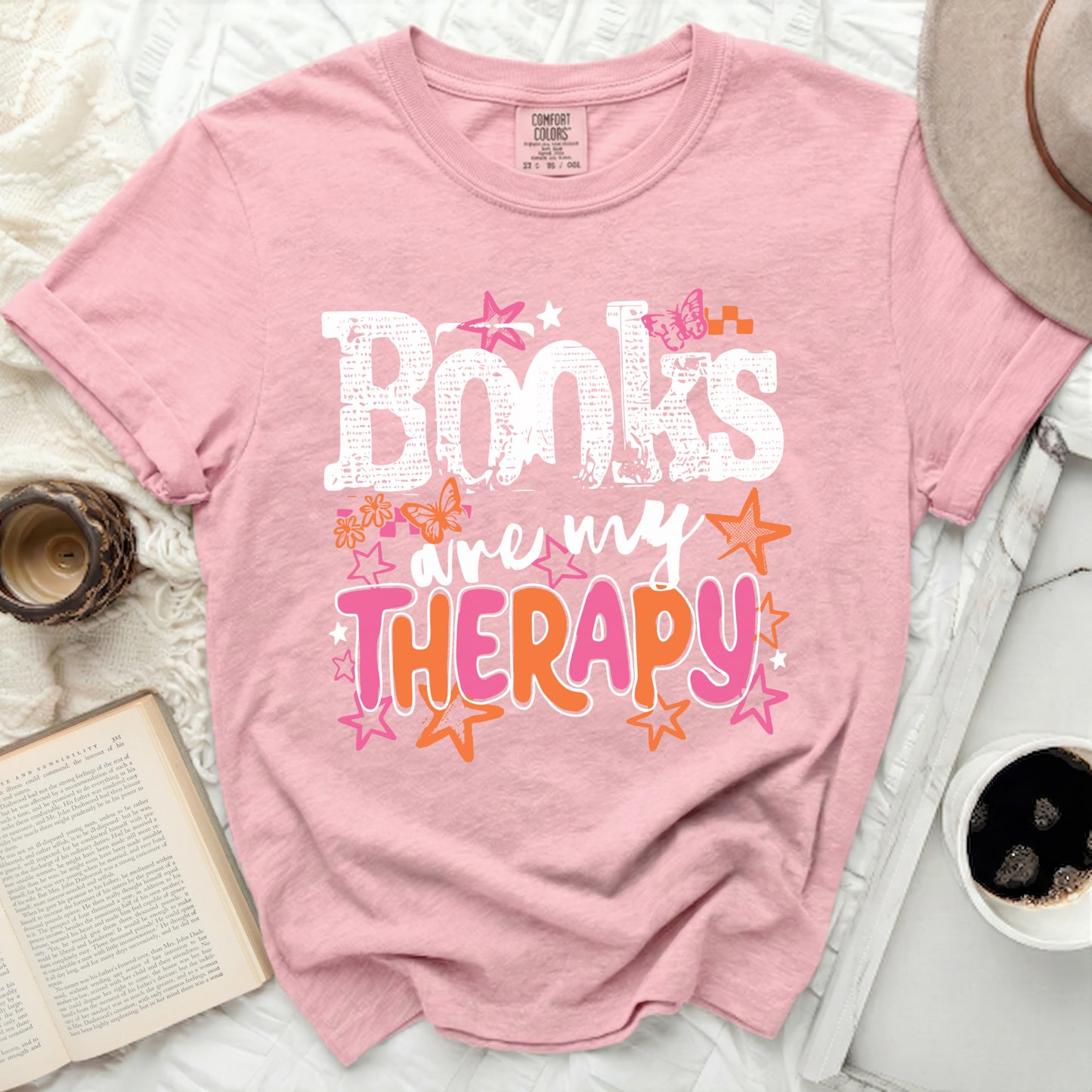 Pink t-shirt with "Books are my Therapy" graphic and butterflies.