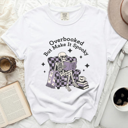 Skeleton in armchair reading "Tome Sweet Tome" with text "Overbooked But Make It Spooky".