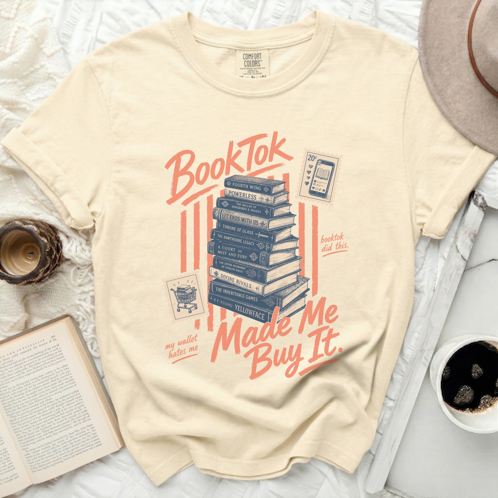 BookTok stack of books graphic on a cream t-shirt, "my wallet hates me" and "Made Me Buy It."