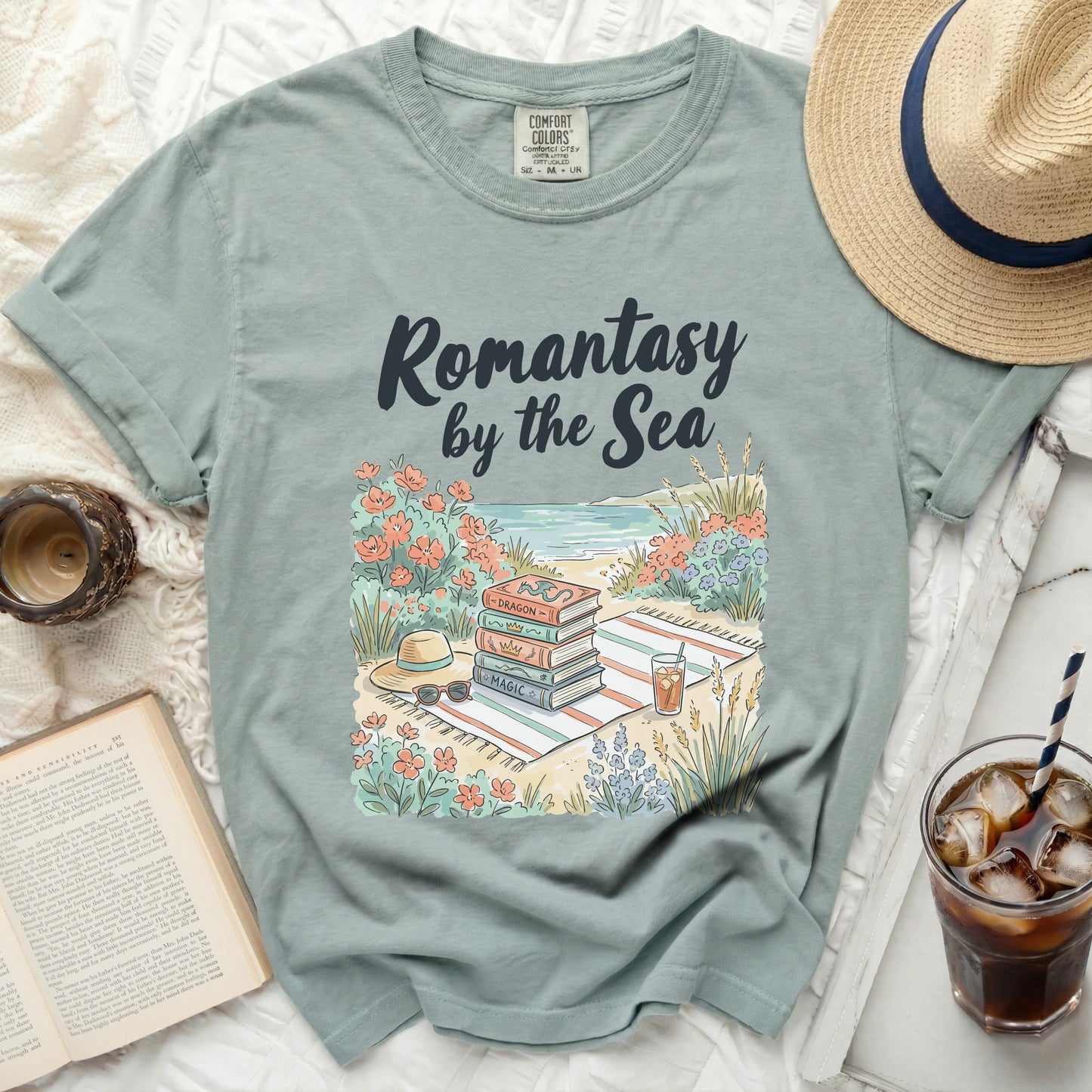 T-shirt with "Romantasy by the Sea" and stack of books.
