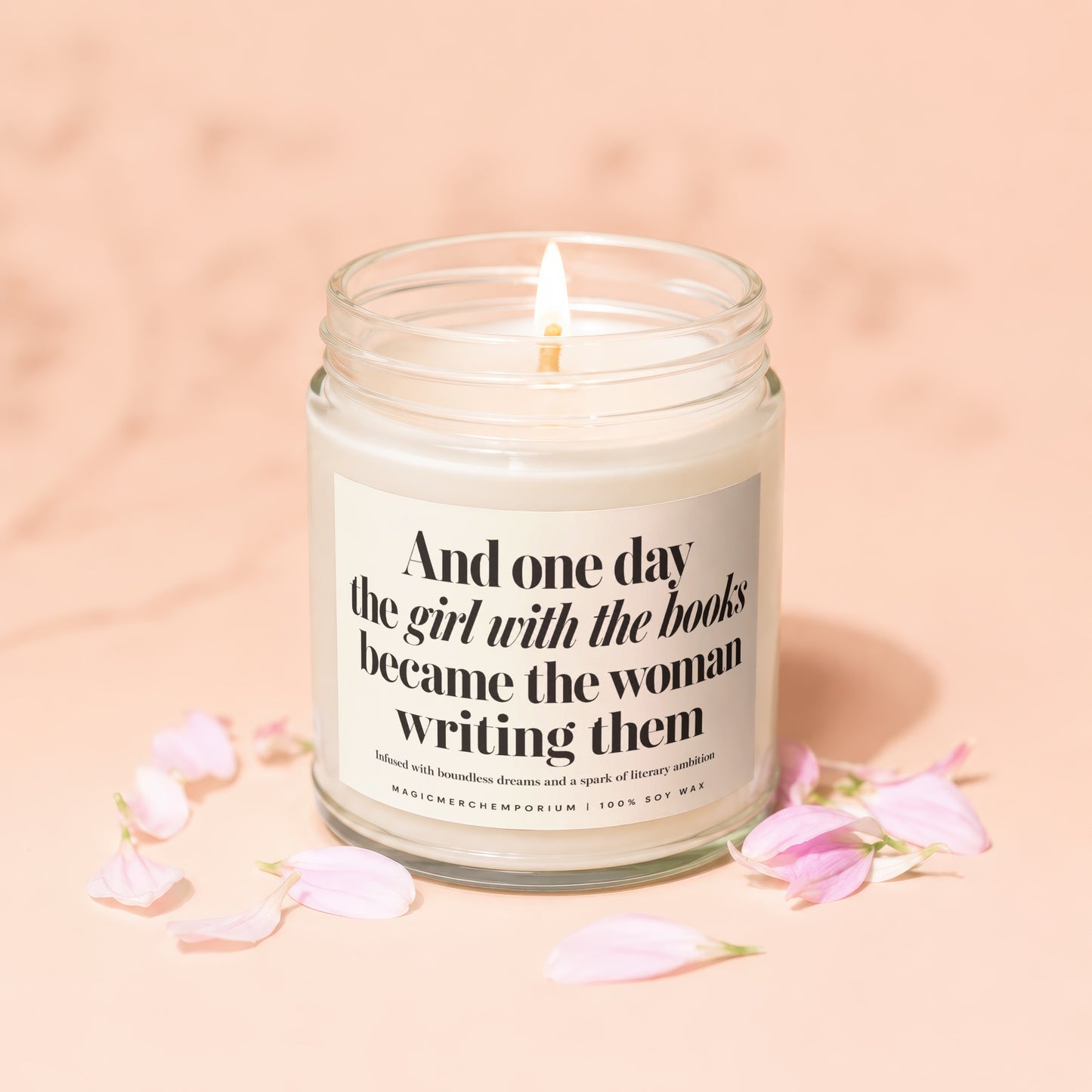 Lit candle with text "And one day the girl with the books became the woman writing them".