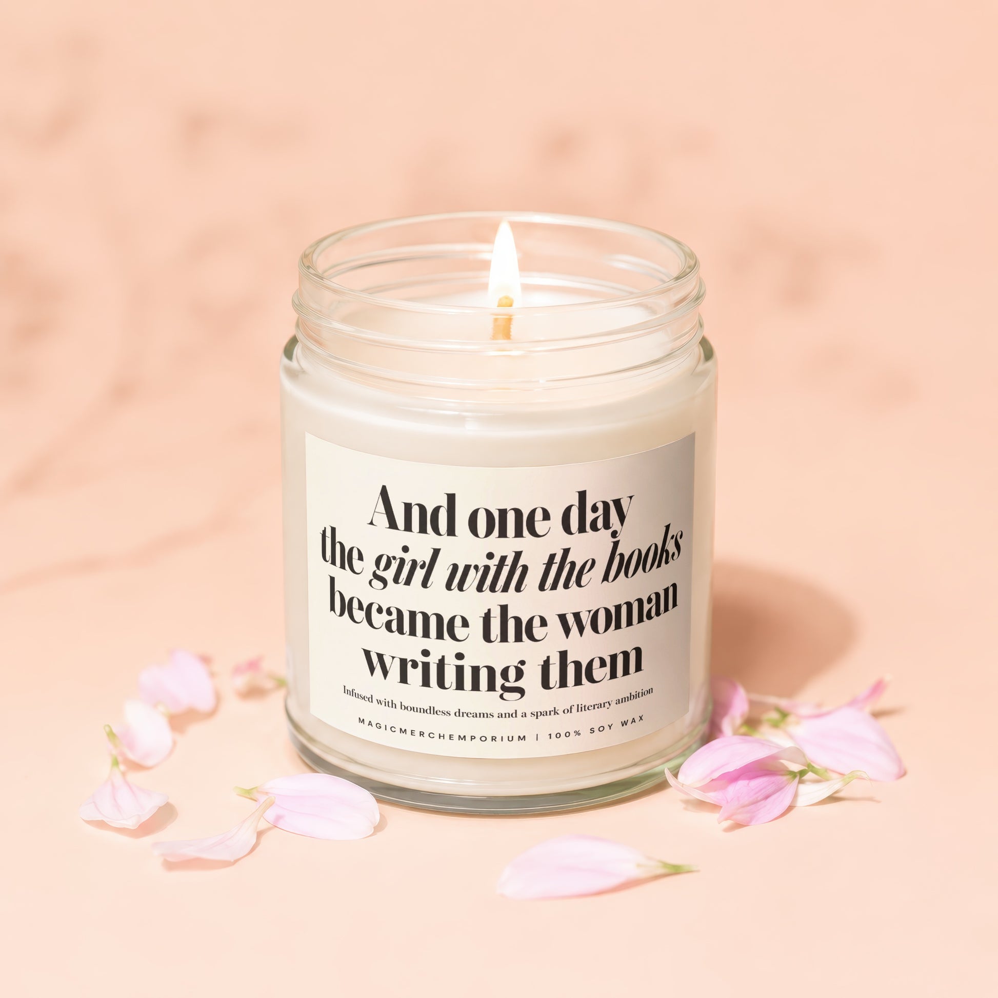 Lit candle with text "And one day the girl with the books became the woman writing them".