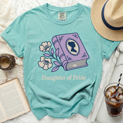 Teal t-shirt with book, flowers, and "Daughter of Pride" text.