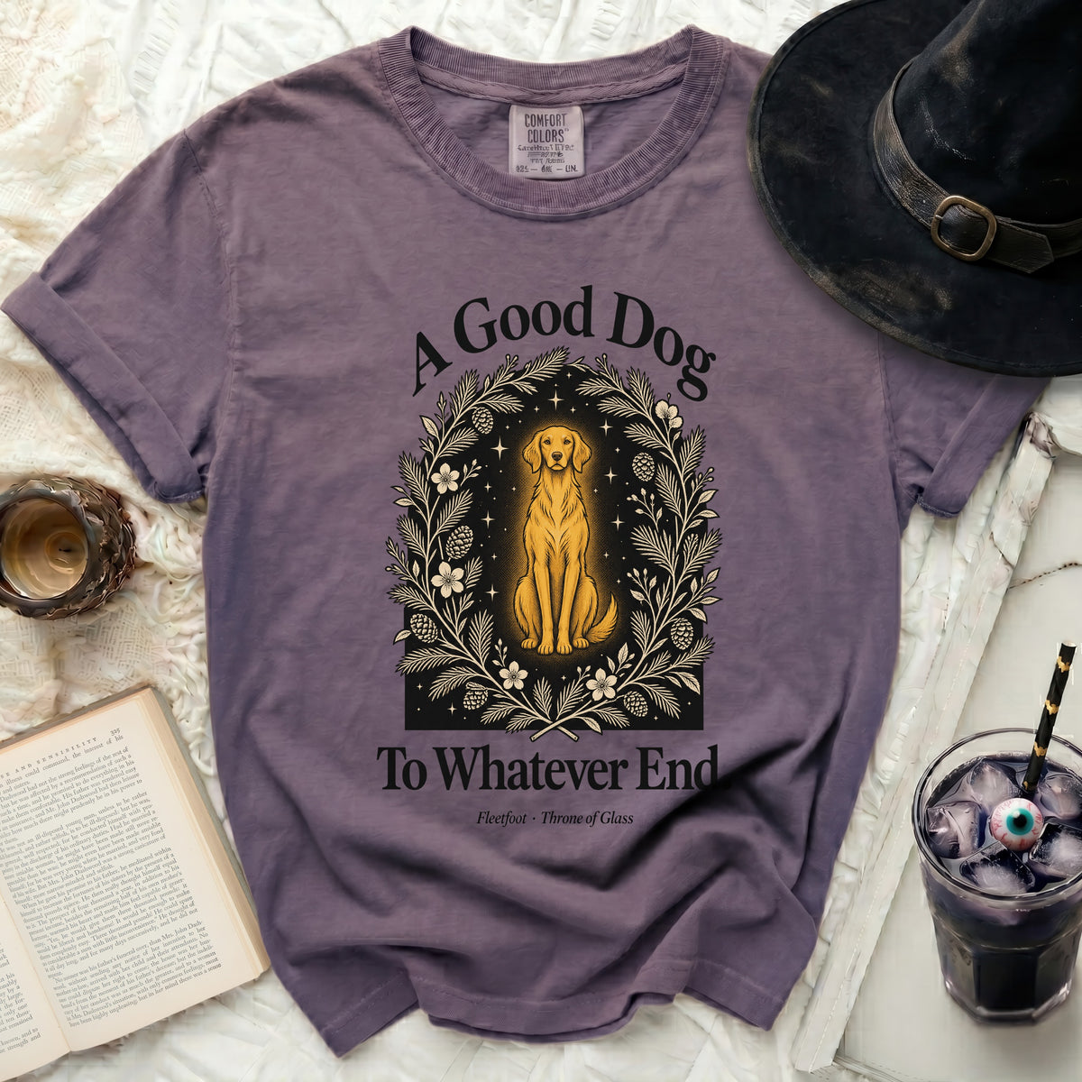 Purple t-shirt with "A Good Dog To Whatever End" and golden dog graphic.