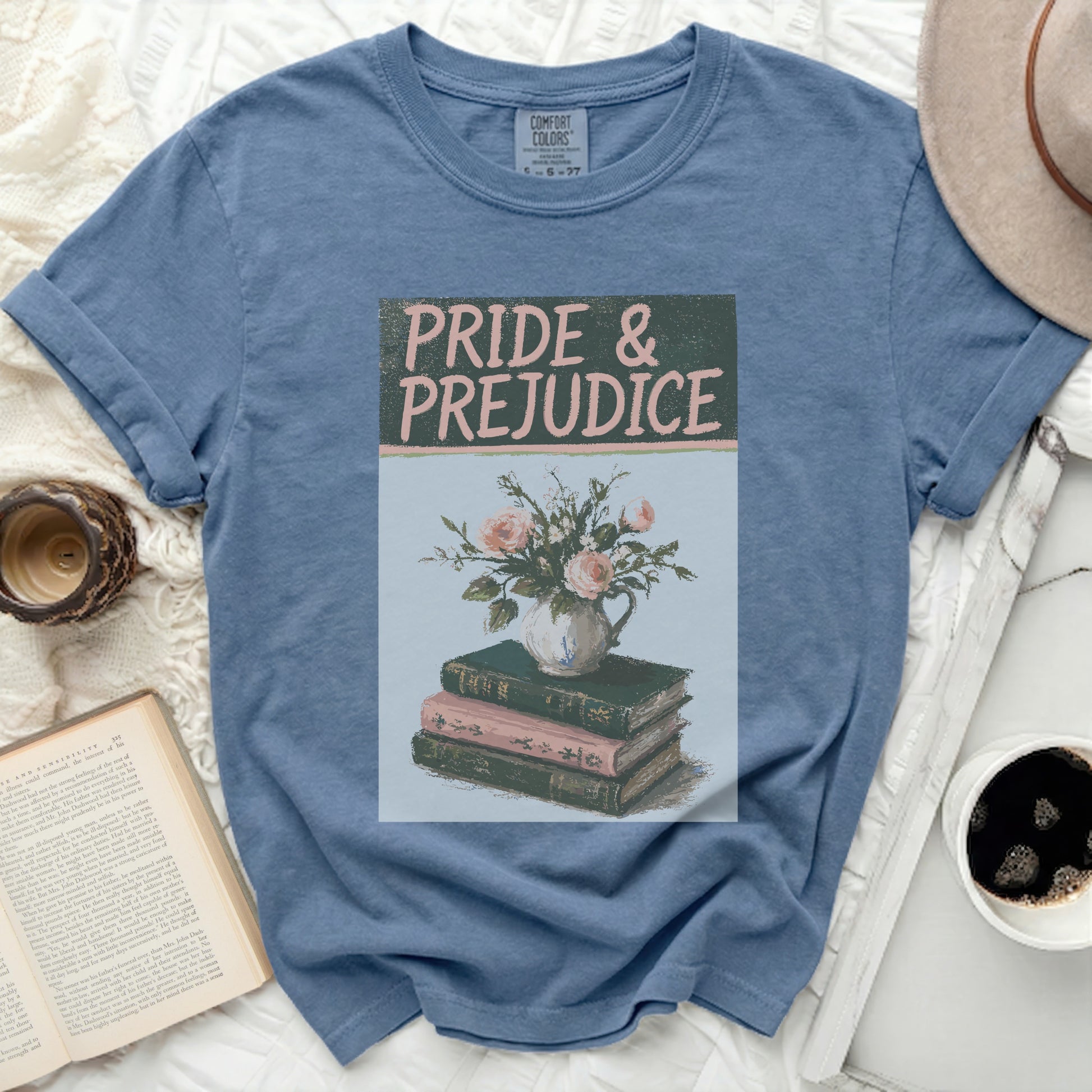 Blue t-shirt with "Pride & Prejudice" text and floral book design.