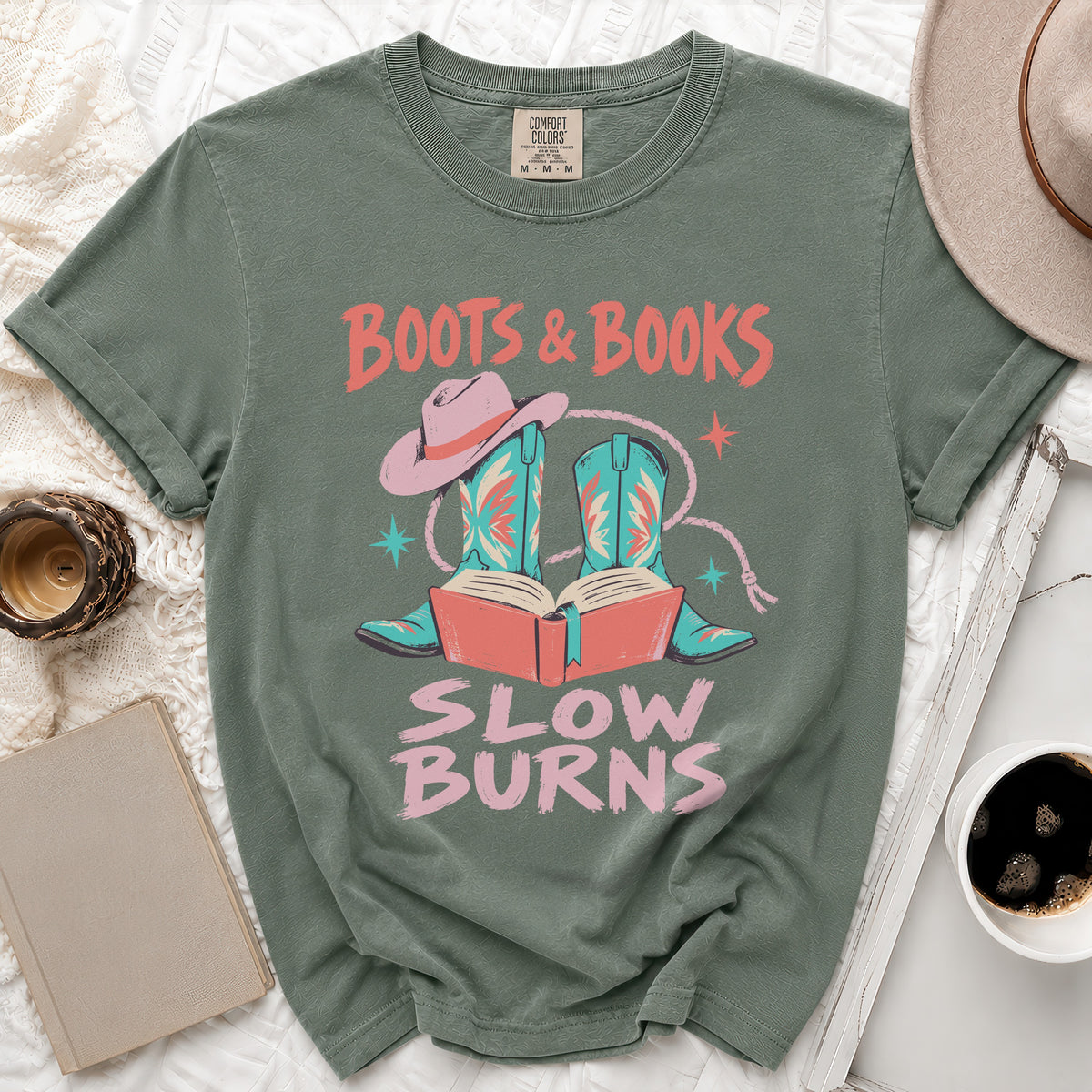 T-shirt with text "Boots & Books Slow Burns" and graphic of boots and book.