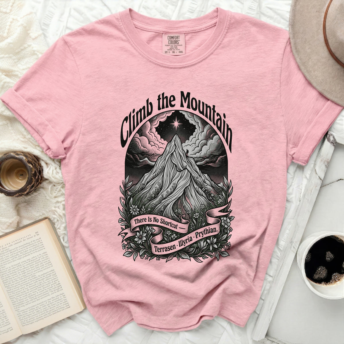 Pink t-shirt with "Climb the Mountain" graphic featuring a mountain, star, and text.