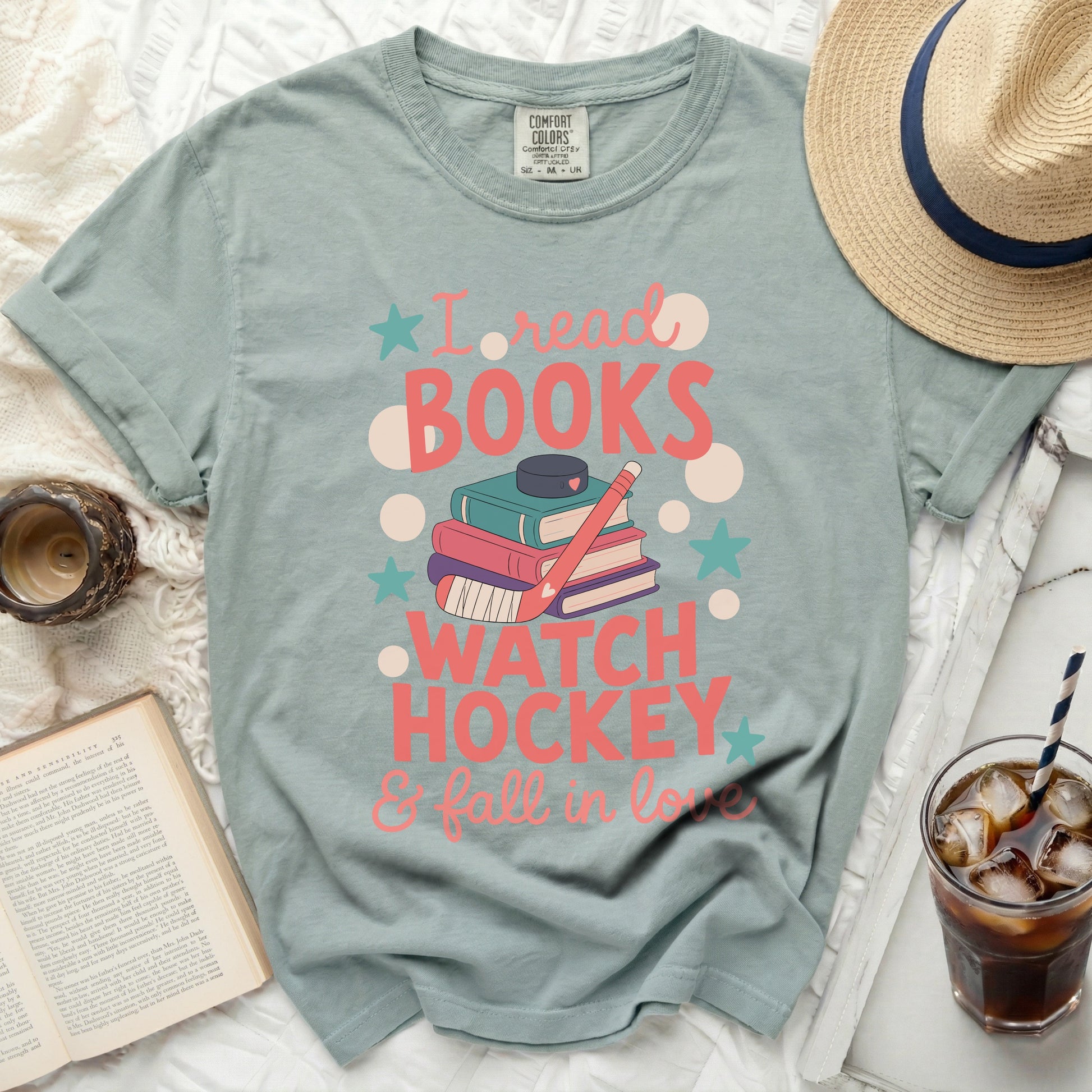 Green t-shirt with "I read books, watch hockey & fall in love" text.
