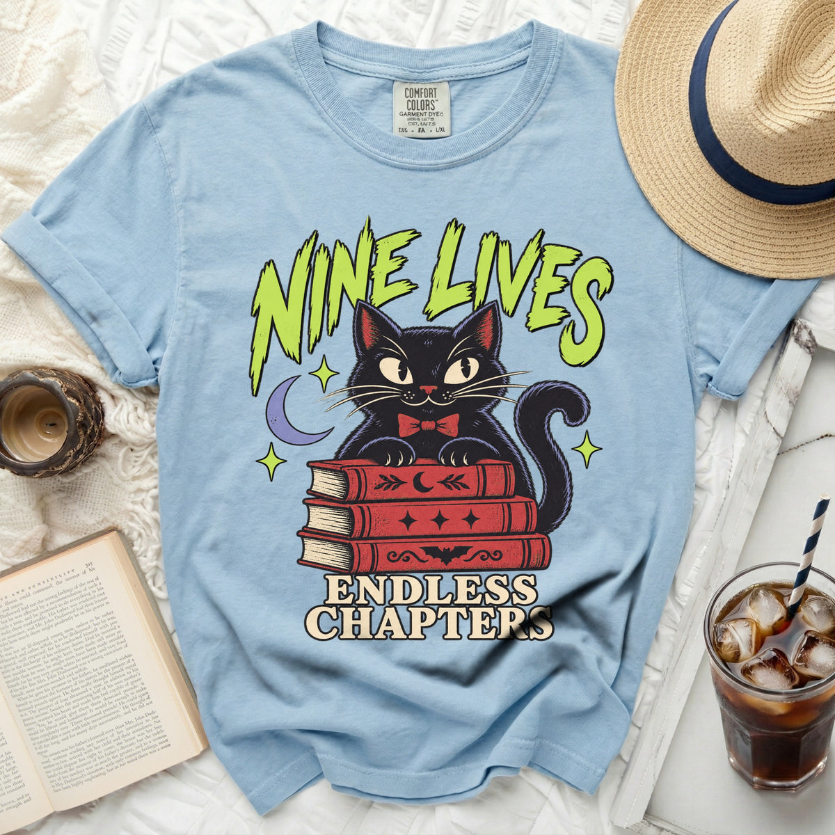 Black cat on books with "NINE LIVES ENDLESS CHAPTERS" text.