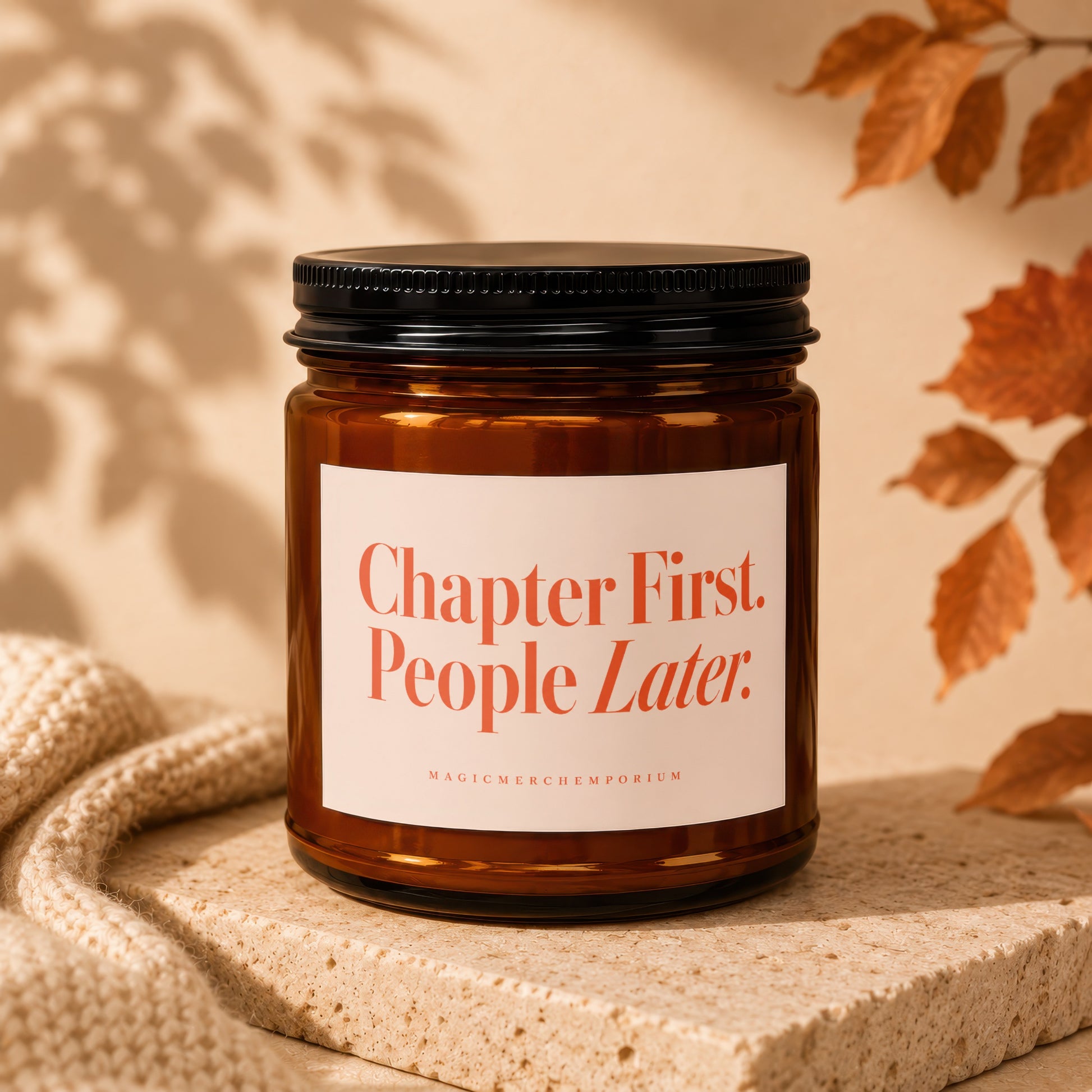 Amber jar candle with orange label reading "Chapter First. People Later."