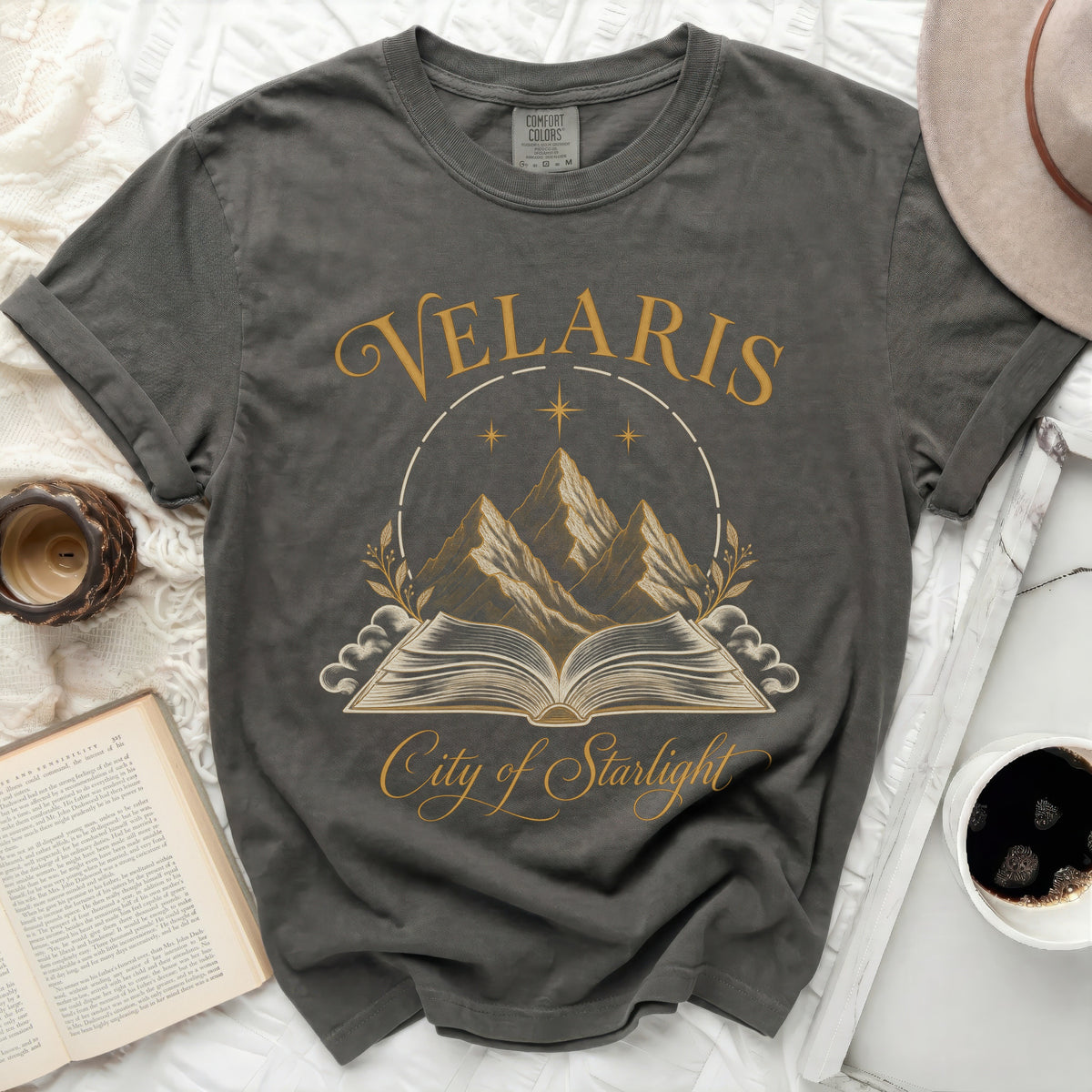 Dark grey t-shirt with "Velaris City of Starlight" text and celestial mountains graphic.