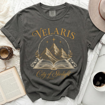 Dark grey t-shirt with "Velaris City of Starlight" text and celestial mountains graphic.