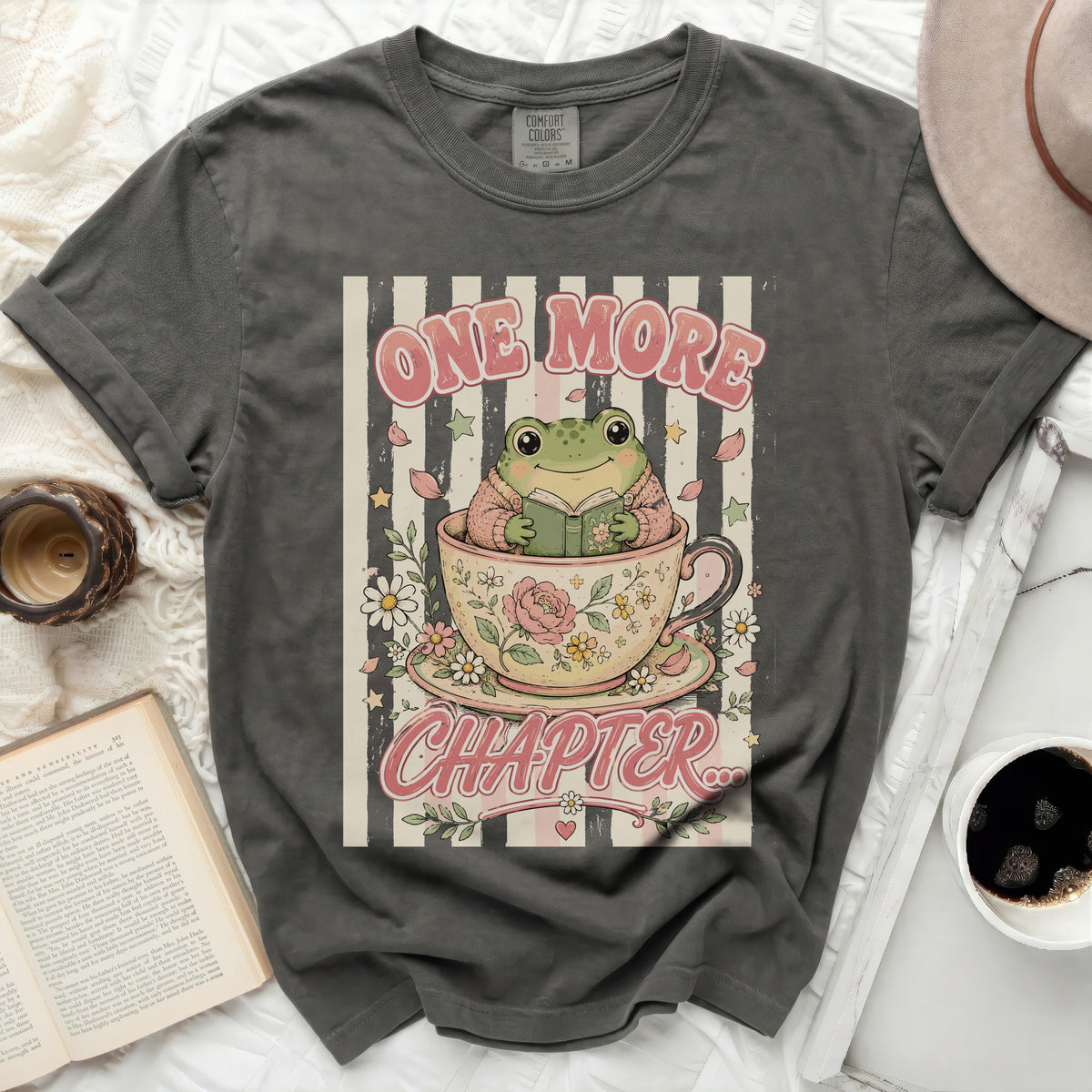 T-shirt with frog reading in teacup and "One More Chapter" text.