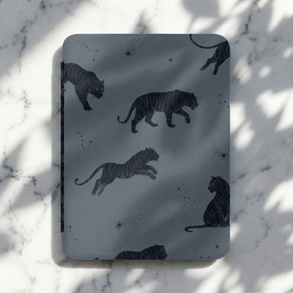 Dark gray cover with a repeating pattern of black tigers and constellations.