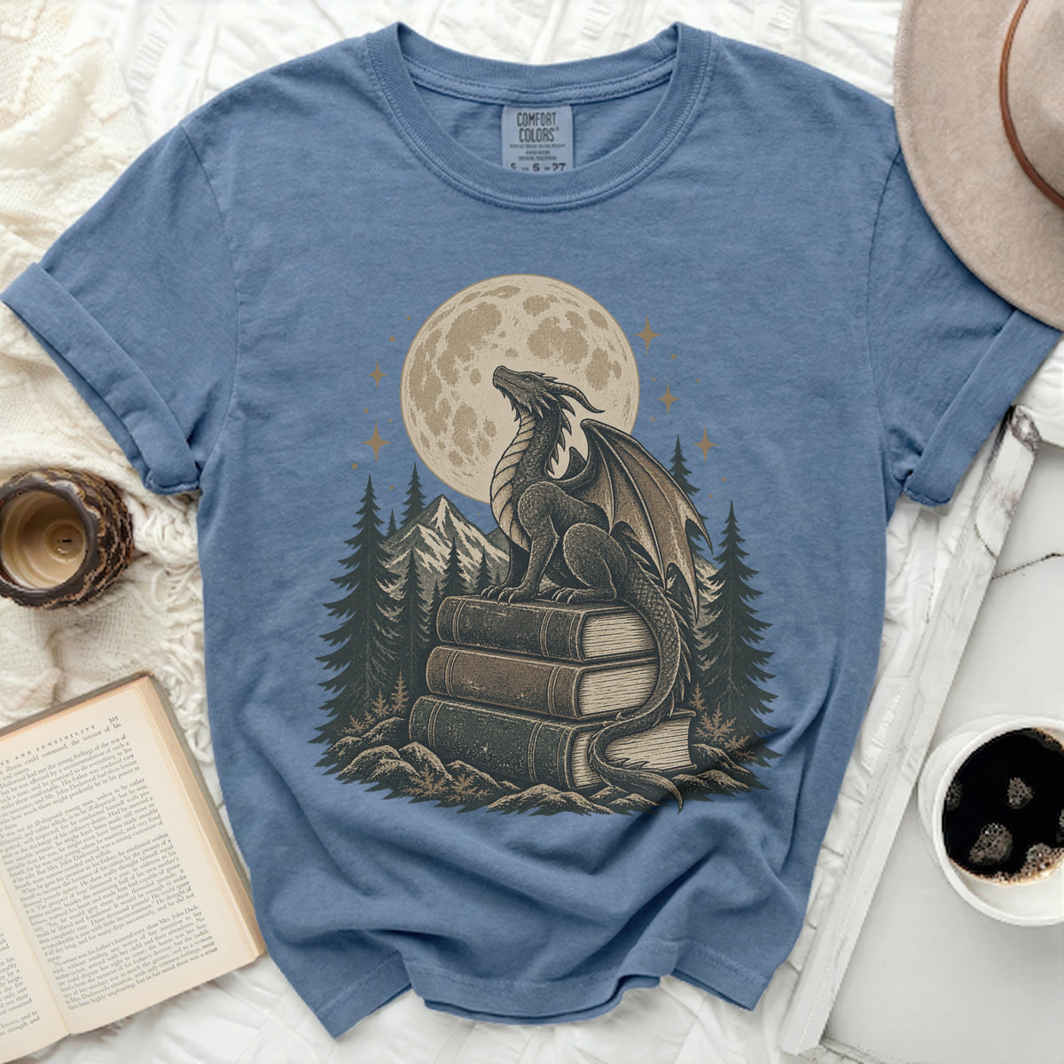 Dragon sitting on books with a moon and mountains in the background.