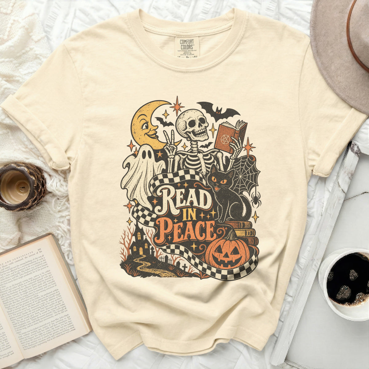 Cream t-shirt with skeleton, ghost, moon, cat, and "Read in Peace" text.