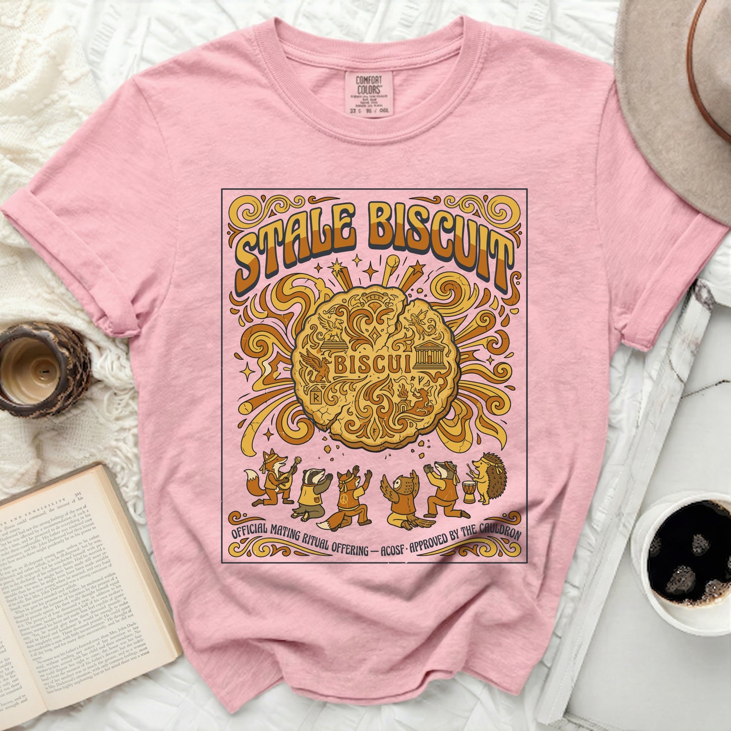 Pink t-shirt with "Stale Biscuit" graphic featuring woodland creatures and a biscuit.