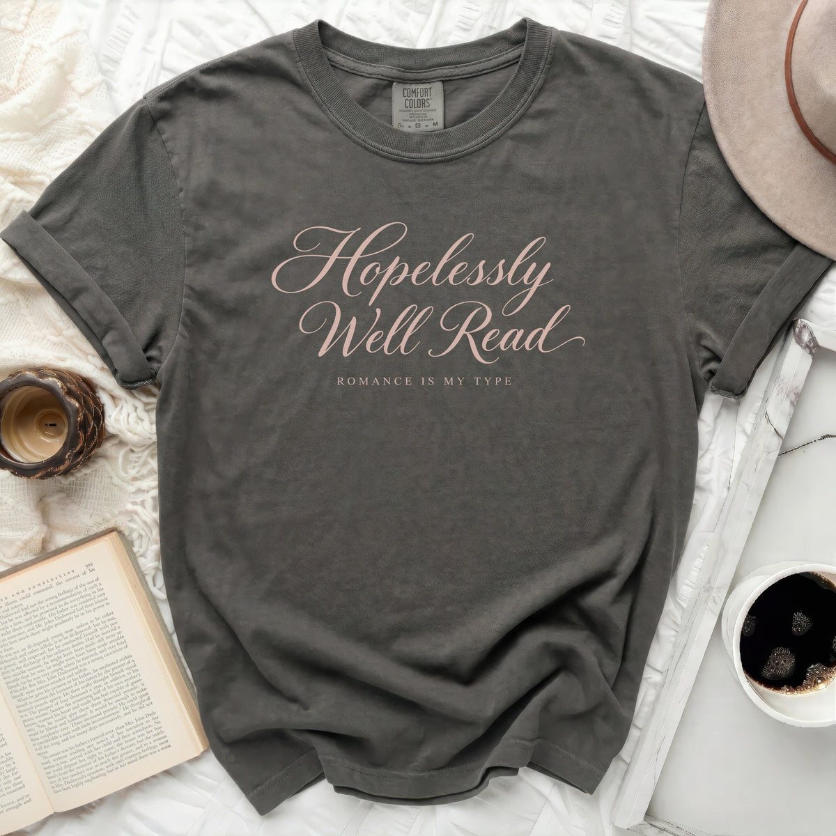 Gray t-shirt with pink text "Hopelessly Well Read" and "Romance Is My Type".