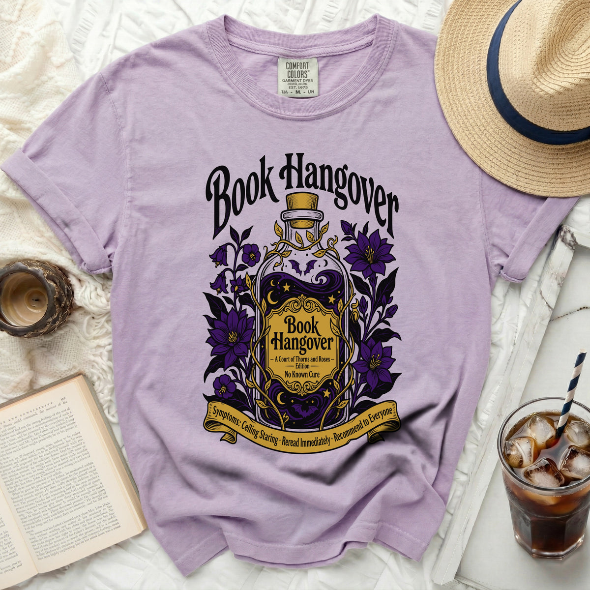 Lavender t-shirt with "Book Hangover" design featuring a potion bottle and purple flowers.