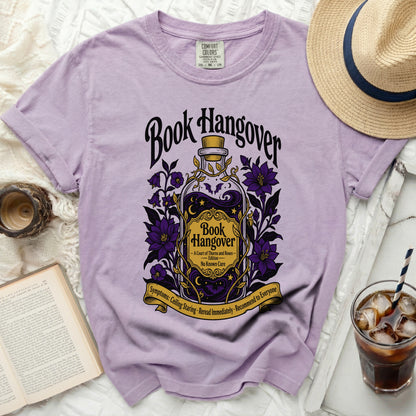 Lavender t-shirt with "Book Hangover" design featuring a potion bottle and purple flowers.