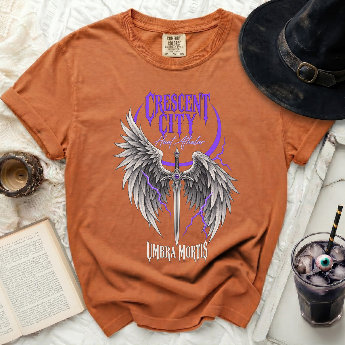 Orange t-shirt with "Crescent City Hunt Athalar Umbra Mortis" and winged sword graphic.