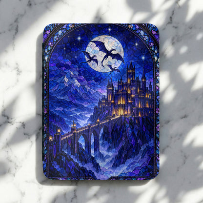 Blue stained-glass e-reader case featuring a castle, a bridge, mountains, dragons, and a large moon.