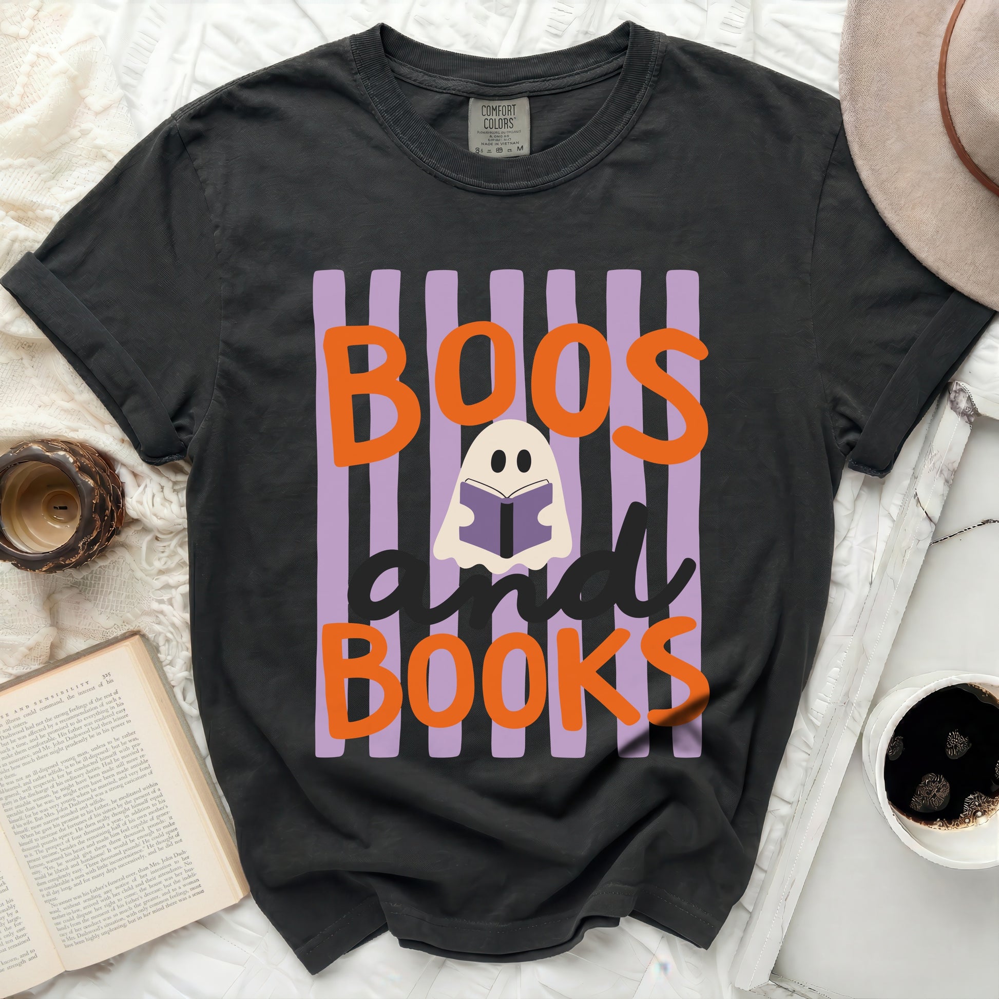 Black t-shirt with "Boos and Books" ghost graphic and purple stripes.