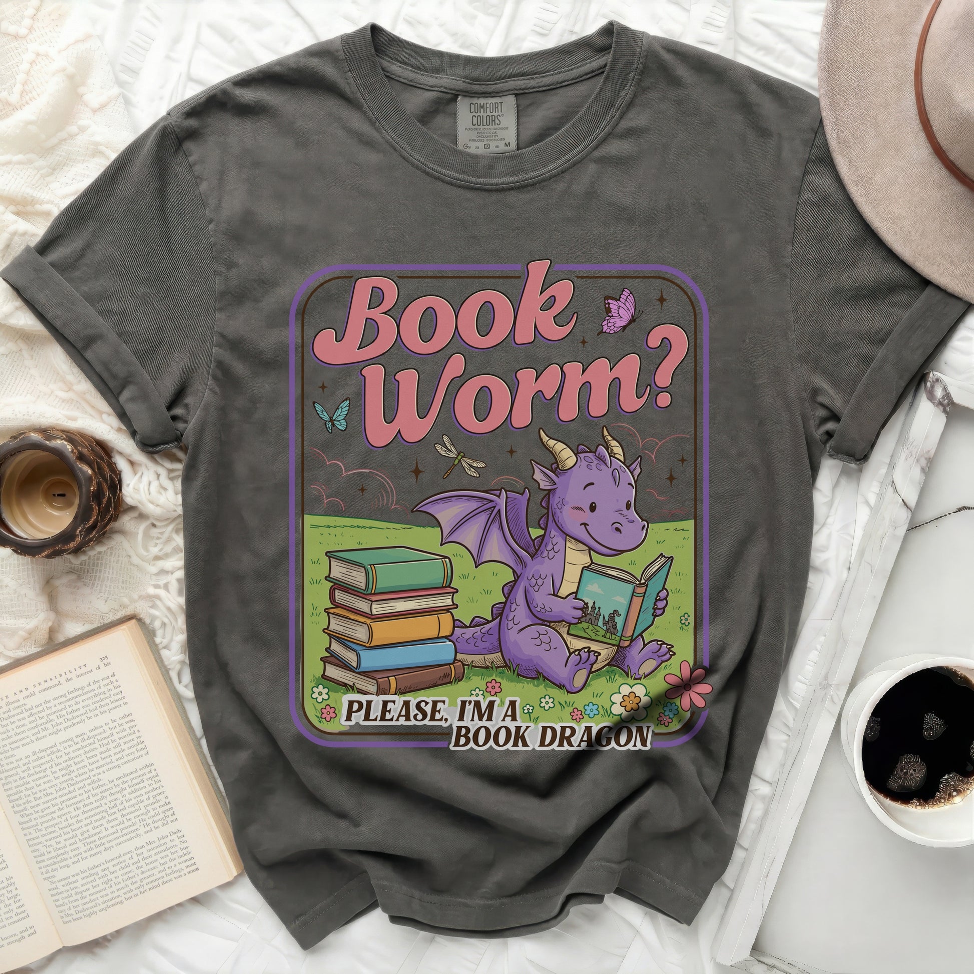 Grey t-shirt featuring a graphic with a purple dragon reading a book, text "Book Worm? Please, I'm a BOOK DRAGON".