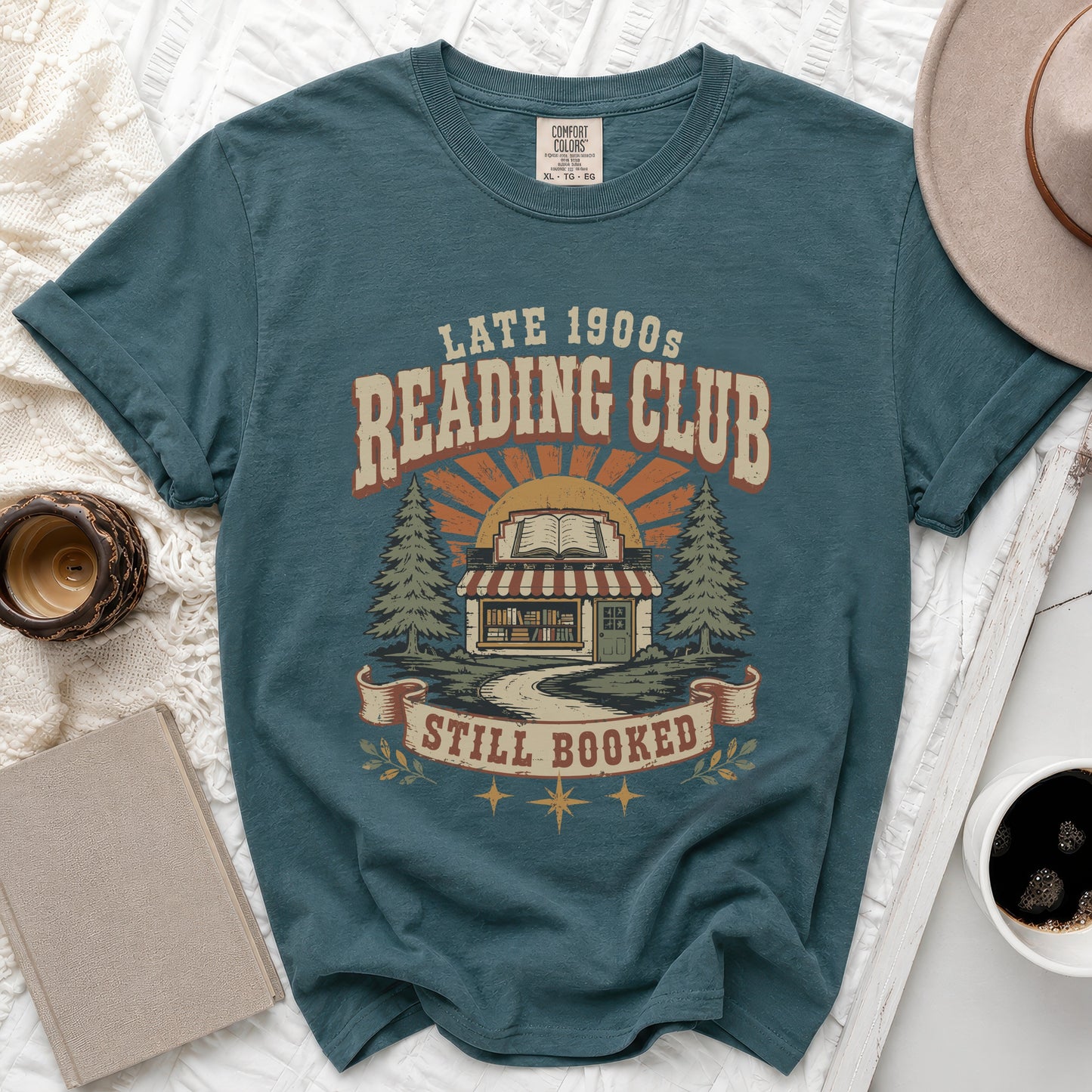 Teal t-shirt with "Late 1900s Reading Club Still Booked" graphic.