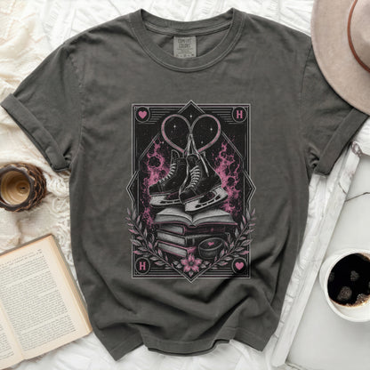 Dark t-shirt with stacked books, ice skates, and heart graphic.