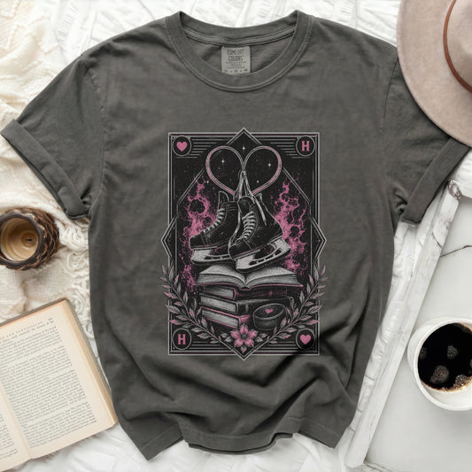 Dark t-shirt with stacked books, ice skates, and heart graphic.