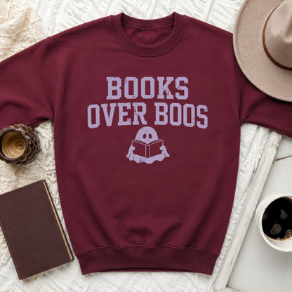 Maroon sweatshirt with "Books Over Boos" text and ghost reading a book.