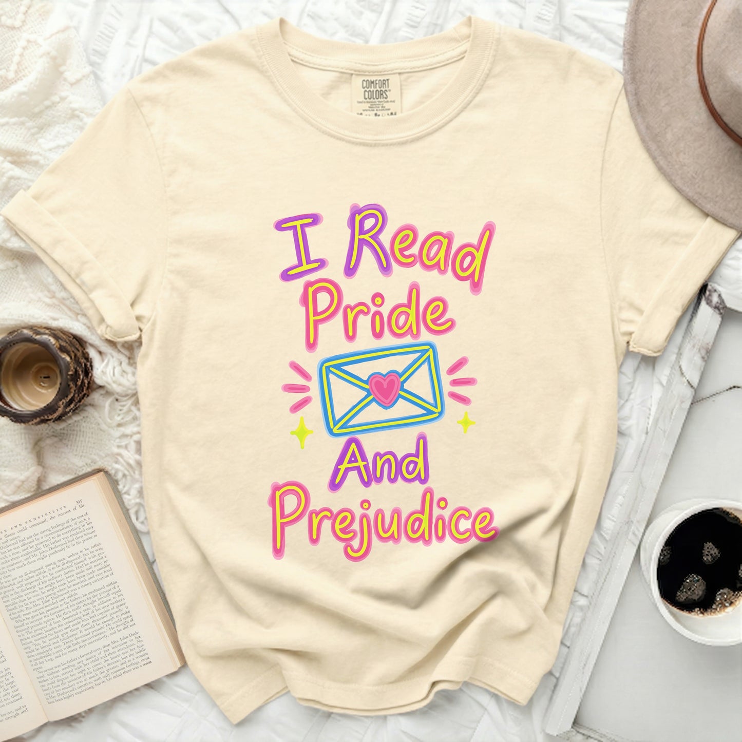 Cream t-shirt with "I Read Pride And Prejudice" text and envelope graphic.