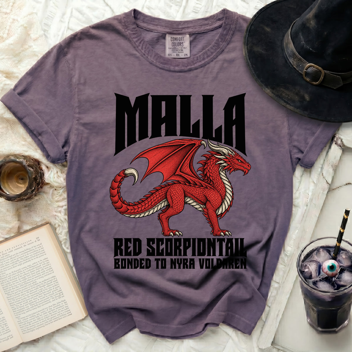 Purple t-shirt with a red dragon graphic and text "MALLA RED SCORPIONTAIL BONDED TO NYRA VOLDAREN".