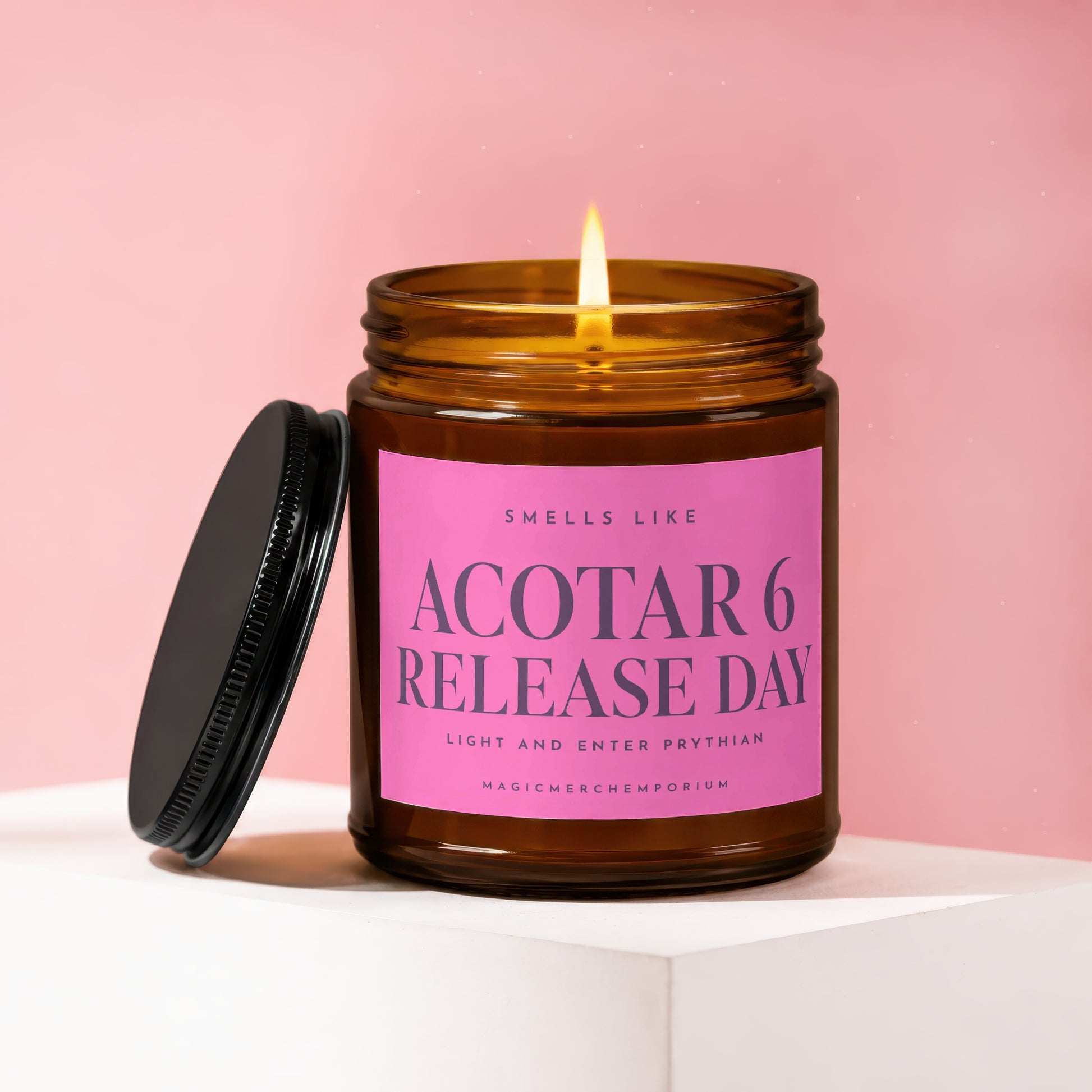 Amber candle with pink label reading "ACOTAR 6 RELEASE DAY".