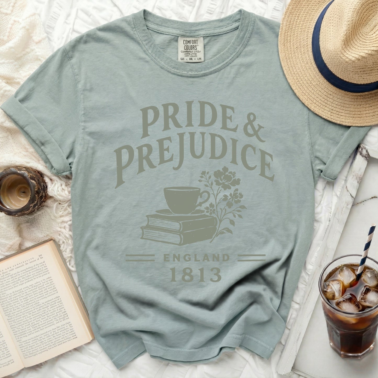 Pride and Prejudice t-shirt with books, teacup, and flowers graphic.