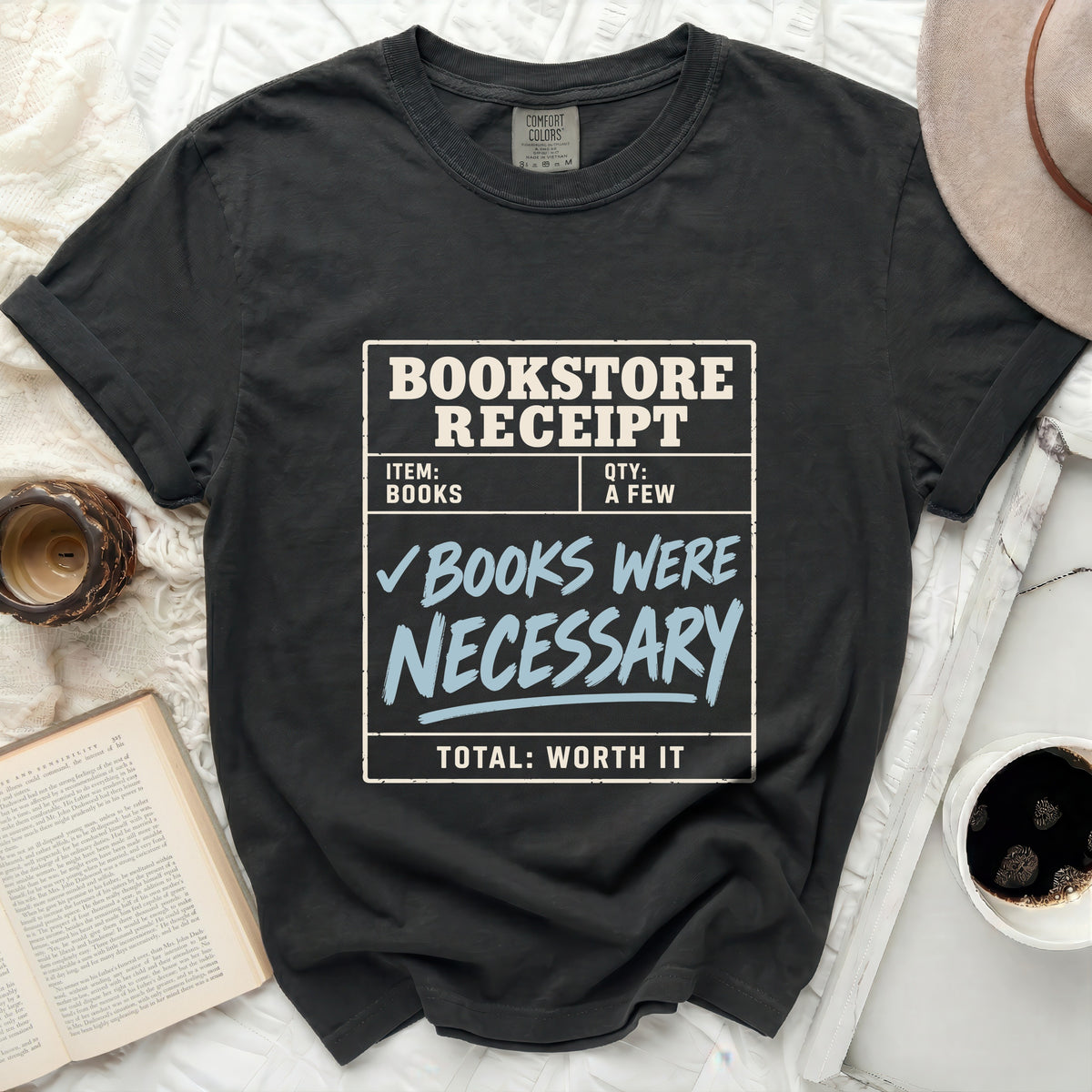 Dark grey t-shirt with "Bookstore Receipt: Books Were Necessary" graphic.