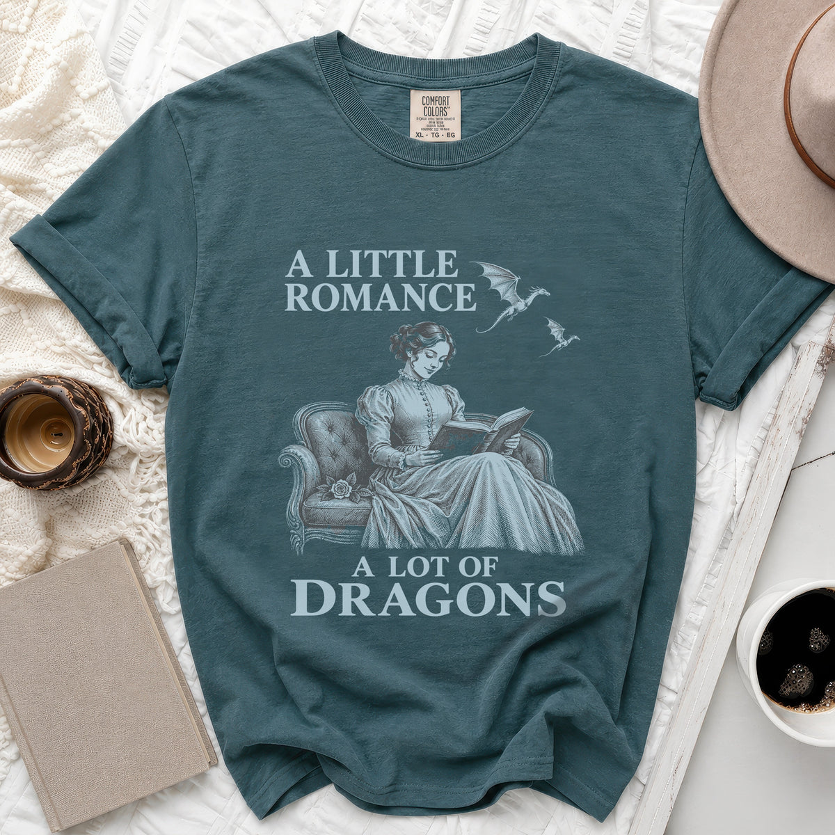 Teal t-shirt with "A Little Romance A Lot of Dragons" text and dragon graphics.