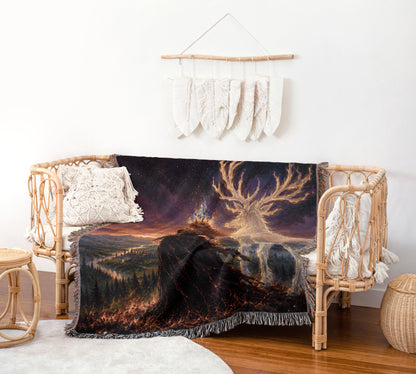 a cozy living room with a wicker bench, a woven basket, and a woven rug. The bench is adorned with a large woven blanket depicting a forest scene with a castle in the distance. The blanket has a striking black and orange color scheme, and the blanket is draped over the bench, creating a visually appealing and inviting atmosphere.