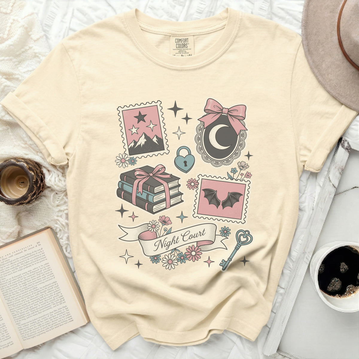 Cream t-shirt with "Night Court" and whimsical illustrations of stamps.