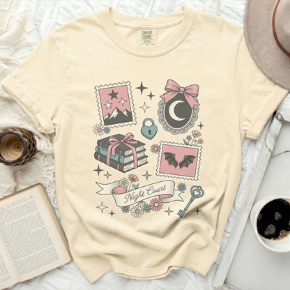 Cream t-shirt with "Night Court" and whimsical illustrations of stamps.
