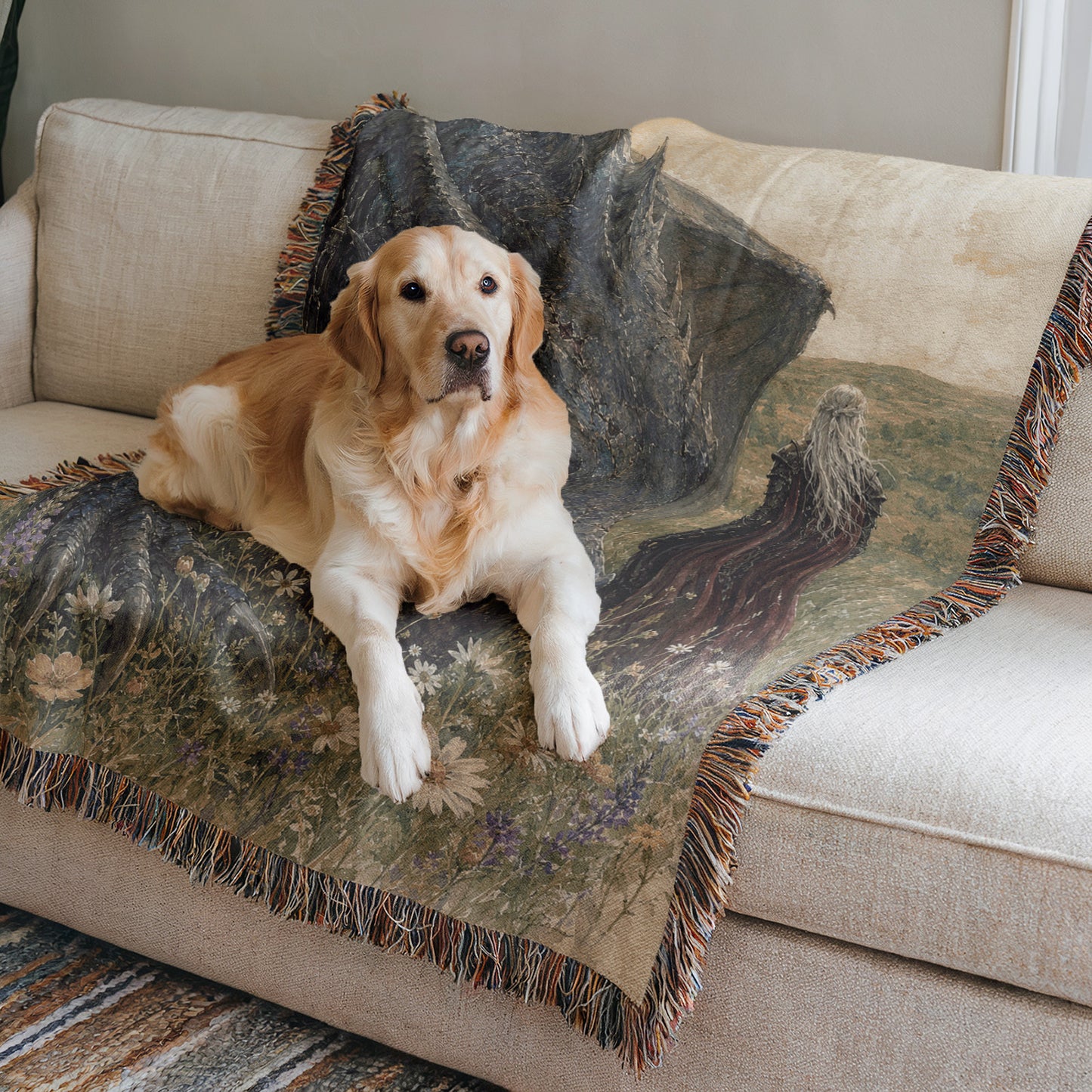 A golden retriever dog is lying on a couch with a colorful blanket featuring a landscape design.