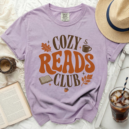 Lavender t-shirt with "Cozy Reads Club" graphic, an open book, and fall leaves.