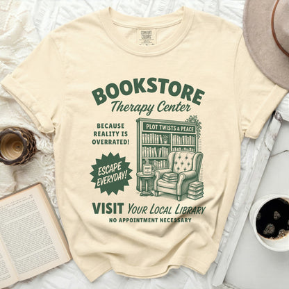 Bookstore Therapy Center t-shirt with library illustration and book-related text.