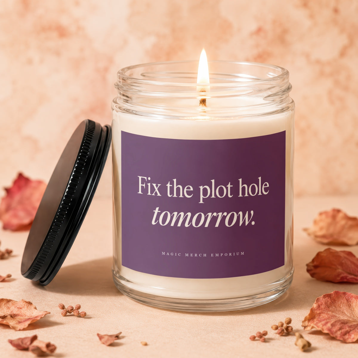 Lit candle in glass jar with purple label reading "Fix the plot hole tomorrow."