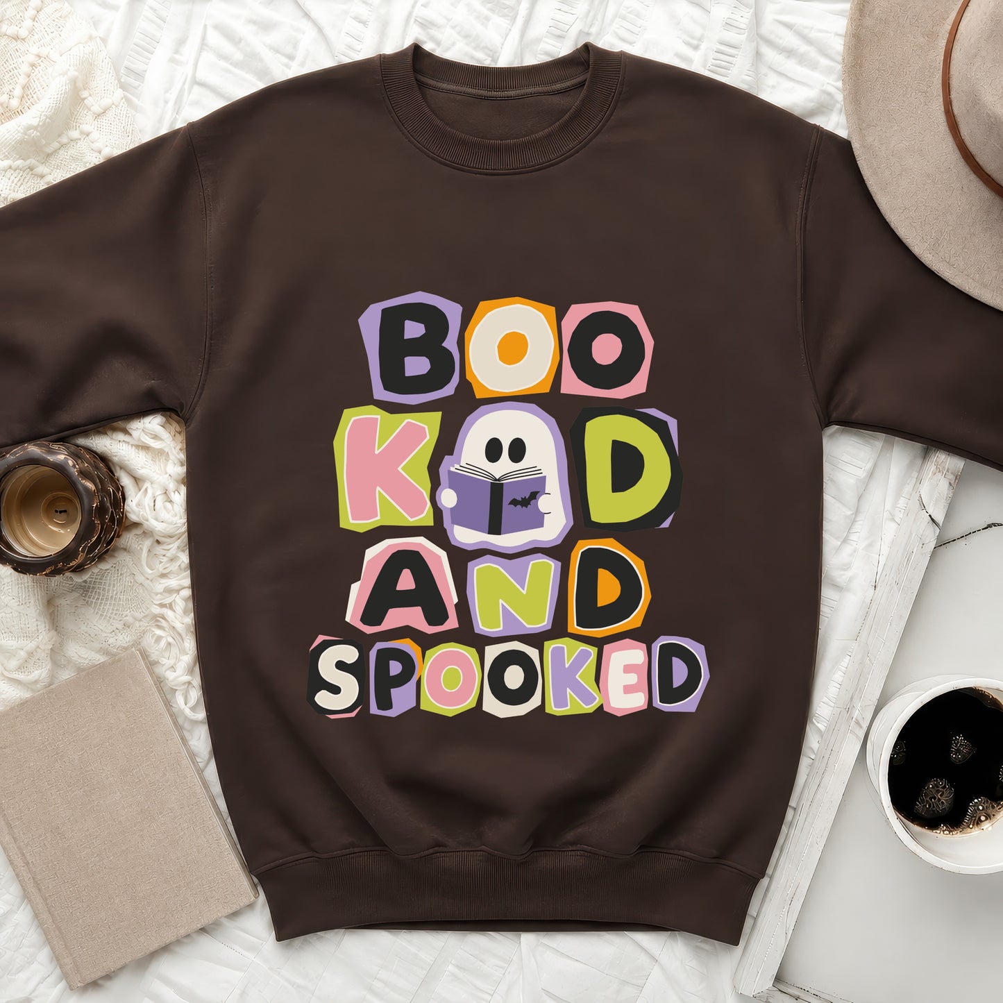 Brown sweatshirt with "Boo, Kind, and Spooked" Halloween graphic.