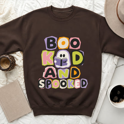 Brown sweatshirt with "Boo, Kind, and Spooked" Halloween graphic.